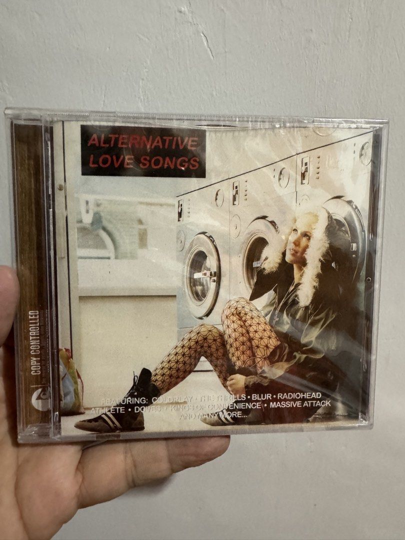 Alternative Love Songs CD (Category: CDs & DVDs) located in San Juan City. Submitted by redgecollection (Listing ID 1435374809, Image 1). Description: Sealed - Alternative Love Songs CD - Featuring artists: Massive Attack, Blur, Radiohead, and more - Tracklist includes: "Teardrop", "Song 2", "No Distance Left to Run" - Compilation of alternative love songs - CD case visible in images.