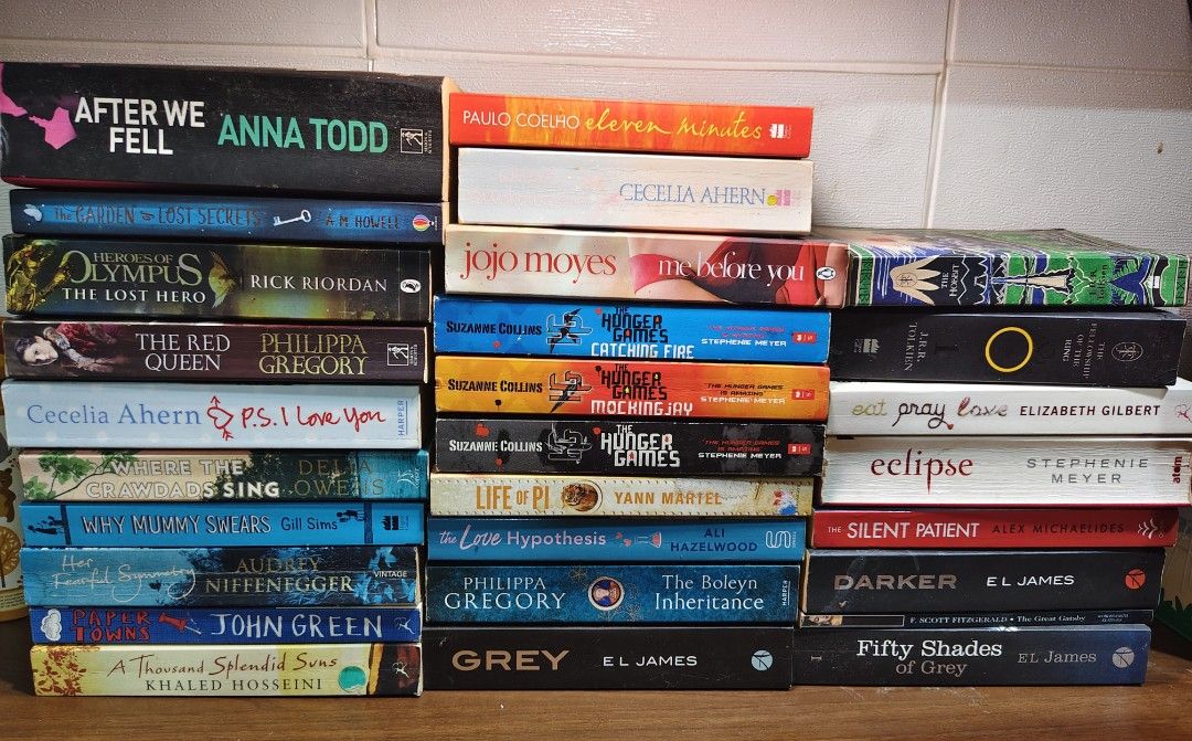 Assorted Paperback Books (Category: Storybooks) located in Las Pinas. Submitted by mommy_14 (Listing ID 1435386650, Image 2). Description: - Paperback book collection. - Includes titles: "The Secret Life of Bees," "The Kissing Booth," "The Hobbit," "After We Fell," "The Hunger Games," and "Fifty Shades of Grey." - Genres: Romance, Fantasy, and more. - Authors and titles visible in the images..