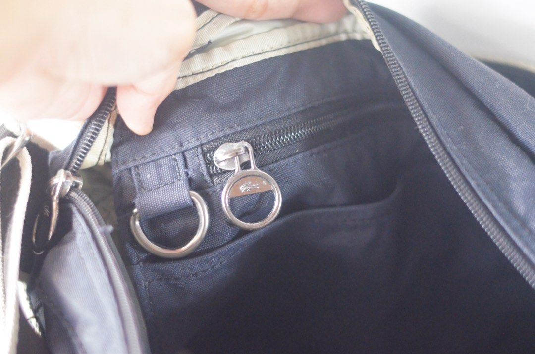 Authentic Lacoste Messenger Sling Crossbody Bag (Category: Luxury Bags & Wallets) located in Quezon City. Submitted by vintageavenueph (Listing ID 1435347904, Image 3). Description: PLEASE READ FIRST! - Authentic Lacoste - Preloved/Used - No zipper issues - 9in H x 13in L - Adjustable wide long strap - Very durable bag. No tear on the strap. - Can be worn as messenger/crossbody - Some discoloration on the strap and at the back of the bag. See act