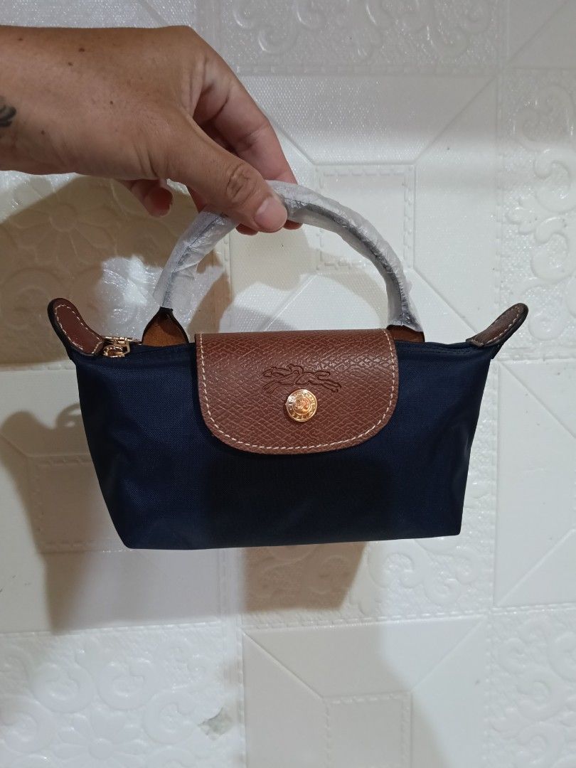 Authentic/Legit 💯 Longchamp Le Pliage Mini Sling Bag (Category: Luxury Bags & Wallets) located in Manila. Submitted by archie_doroy (Listing ID 1435374575, Image 3). Description: Authentic/Legit 💯 Longchamp Le Pliage Mini Sling Bag Unisex bagay din sa lalaki Made in France Brand new 💯 Kasya Cellphone at Long wallet Retail price 7500 Selling 2500+sf only.