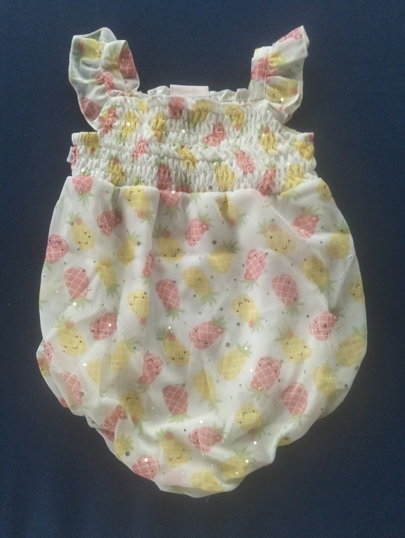 Baby Pineapple Print Romper (Category: Babies & Kids Fashion) located in Angono. Submitted by ClosetCleanUp (Listing ID 1435387848, Image 1). Description: - Adorable baby romper - Playful pineapple print - Smocked bodice and ruffled sleeves - Comfortable bubble-style bottom - Lightweight fabric, ideal for baby's skin - Perfect for warm weather and playdates.