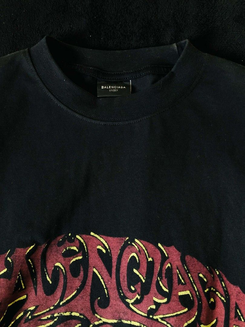 Balenciaga Graffiti Logo T-shirt (Category: Tshirts & Polo Shirts ) located in Cavite. Submitted by devetement (Listing ID 1435366237, Image 3). Description: - Balenciaga black t-shirt - Graffiti-style logo in red and yellow - Brand name on front and back - "ESTABLISHED 2017" detail - Crew neck style - Authentic with visible tag.