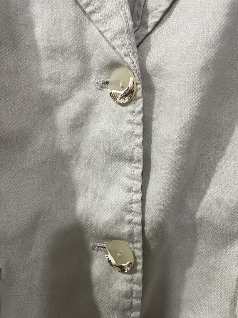Beige Short Sleeve Blazer (Category: Blouses) located in Rizal. Submitted by ethriftstudios (Listing ID 1435446139, Image 3). Description: - Beige short sleeve blazer - Gold-colored buttons - Two front pockets - Unique collar design - Short, puffed sleeves - Tailored back with vertical seams - Perfect for smart casual wear.