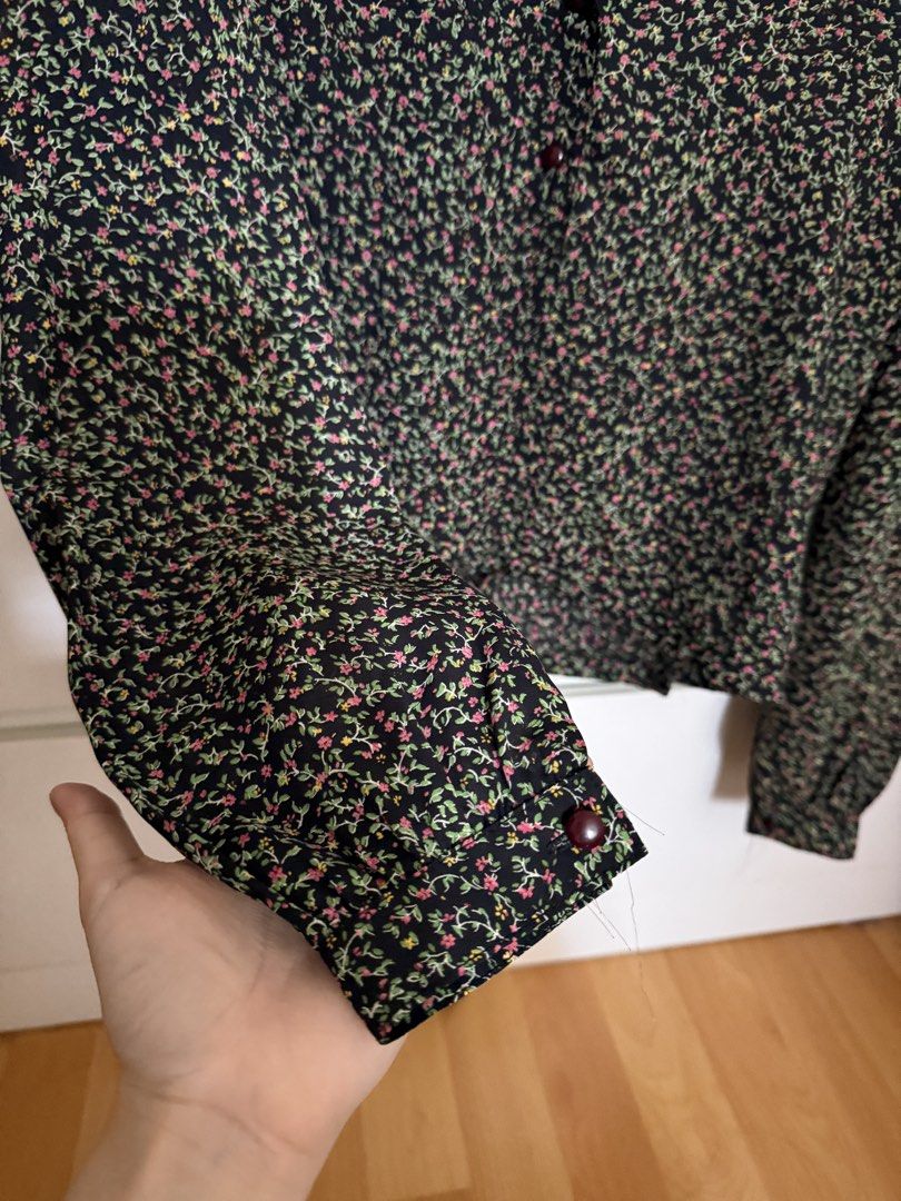 Black Floral Blouse (Category: Blouses) located in Petaling Jaya. Submitted by strowberisundaepreloved (Listing ID 1435379744, Image 3). Description: - Floral print blouse - Colors: Pink, green, and yellow on black - Long sleeves with buttoned cuffs - Tie waist detail - Unique collar design - Lightweight fabric.