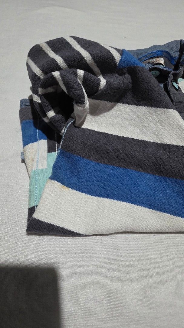 Boys Striped Long Sleeve Shirt (Category: Babies & Kids Fashion) located in Pasig City. Submitted by budolresponsibly (Listing ID 1435465632, Image 3). Description: - Long-sleeved striped shirt - Color scheme: Blue, white, and gray - Features elbow patches - Collared neckline - Back patch detail - Layered bottom hem - Buttoned collar - Small pocket with anchor design -6/7T -Marks & Spencer.