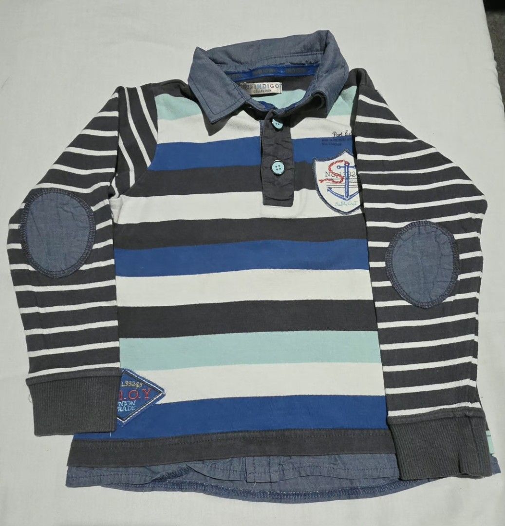 Boys Striped Long Sleeve Shirt (Category: Babies & Kids Fashion) located in Pasig City. Submitted by budolresponsibly (Listing ID 1435465632, Image 1). Description: - Long-sleeved striped shirt - Color scheme: Blue, white, and gray - Features elbow patches - Collared neckline - Back patch detail - Layered bottom hem - Buttoned collar - Small pocket with anchor design -6/7T -Marks & Spencer.