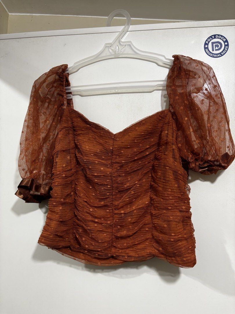 Brown Ruched Top with Puff Sleeves (Category: Blouses) located in Manila. Submitted by sbm_declutters (Listing ID 1435439715, Image 1). Description: - Ruched design - Sweetheart neckline - Sheer puff sleeves with dotted pattern - Ribbon detail at cuffs - Warm brown color - Lightweight, possibly sheer fabric.