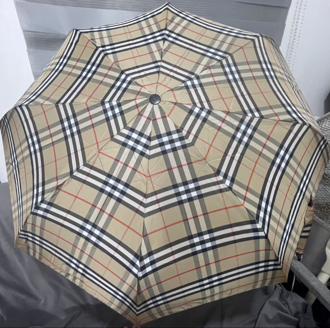 Burberry London Checkered Umbrella (Category: Umbrellas) located in Las Pinas. Submitted by maple0305 (Listing ID 1435503839, Image 3). Description: - Authentic Burberry umbrella - Iconic checkered pattern - Wooden handle with Burberry London logo - Folds up compactly - Includes matching carrying strap.