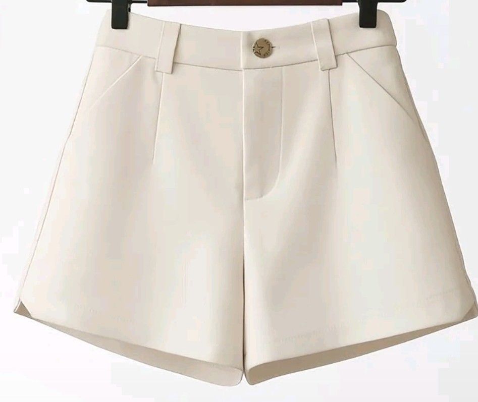 Carine Cream-colored Shorts (Category: Shorts) located in Davao. Submitted by sachigo (Listing ID 1435369369, Image 2). Description: - Cream-colored shorts - Button closure - Zipper - Elastic waistband - Low waist: 16 inches - Length: 12.5 inches - Features pockets - Smooth, possibly synthetic fabric.