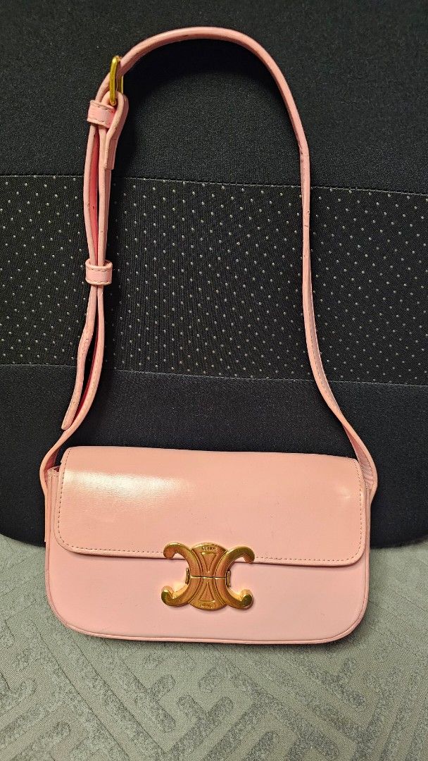 Celine Triomphe Claude shoulder bag (Category: Luxury Bags & Wallets) located in Quezon City. Submitted by jollythrift (Listing ID 1435351655, Image 1). Description: CELINE TRIOMPHE SHOULDER BAG Color: Rose Pink Material: shiny calfskin, sheep leather lining -Measurements : 20 x 10 x 4 cm (length x height x depth) -Triomphe metal texture - lock buckle -Inner flat pocket -Adjustable leather shoulder strap length 20 cm -NGA.
