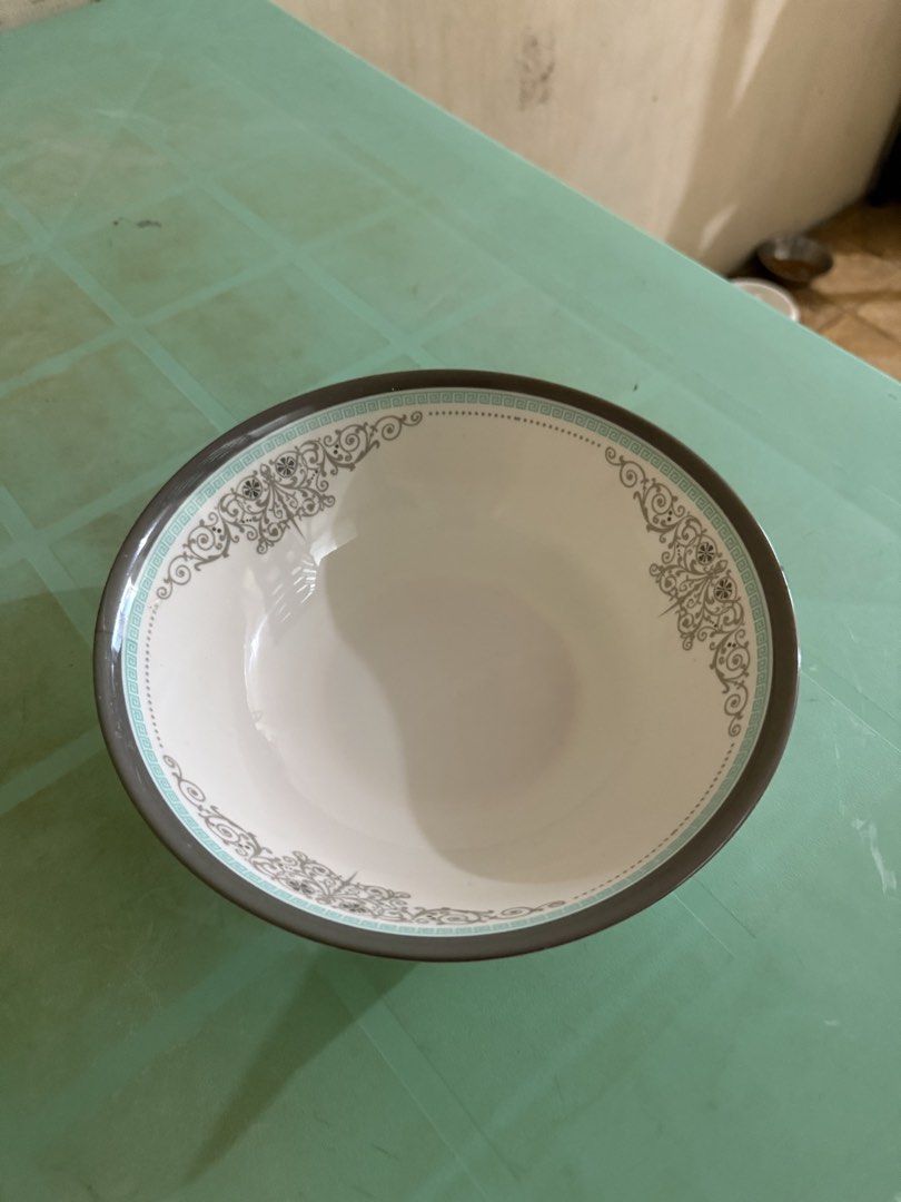 Decorative Bowl with Floral Design (Category: Vases & Decorative Bowls) located in Quezon City. Submitted by kayelg (Listing ID 1435364183, Image 1). Description: - White interior with a decorative floral rim. - Features a gray border with a light blue accent. - Made of ceramic or similar material. - Ideal for serving soups, cereals, or snacks. - Adds a touch of elegance to your table setting..