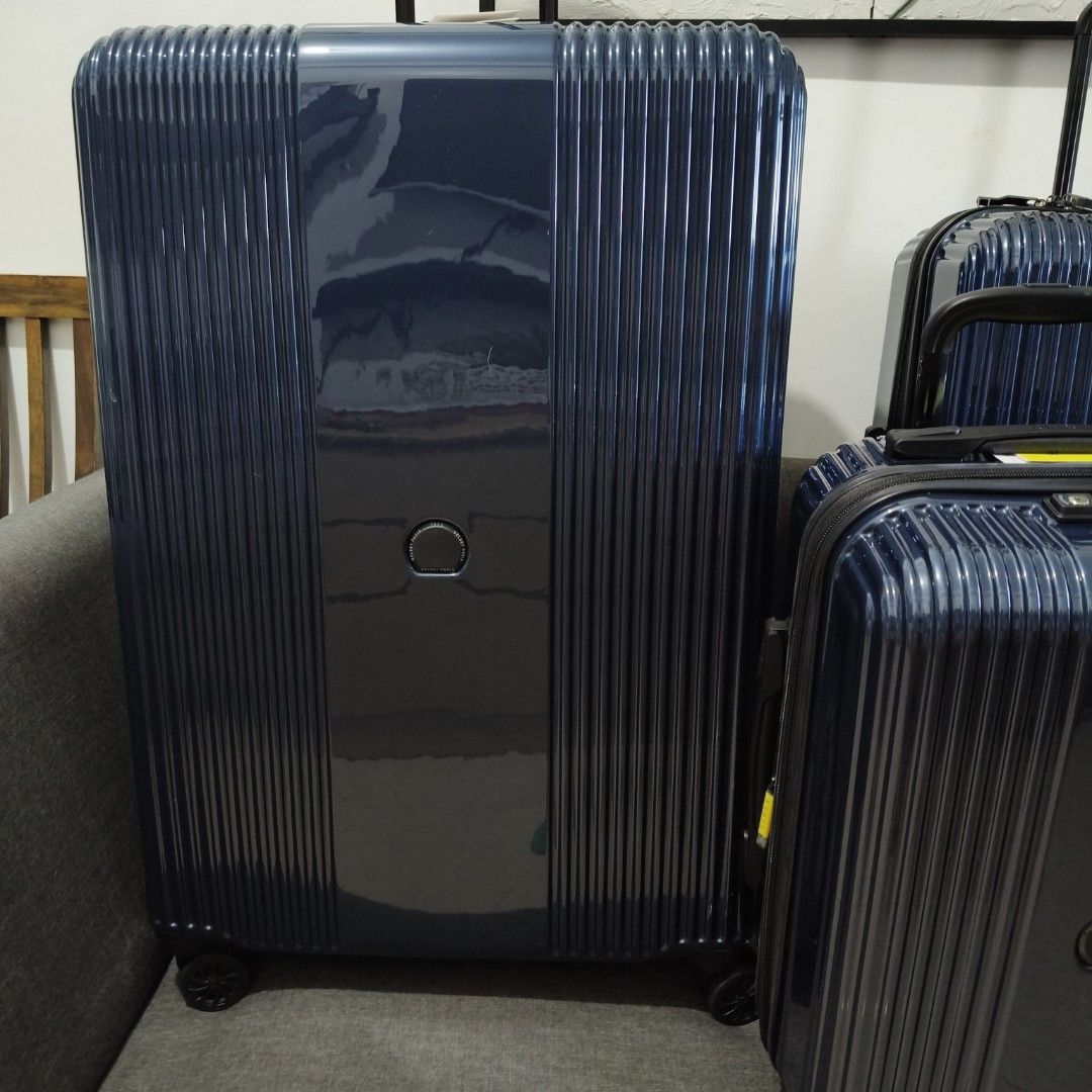 Delsey Luggage - Navy Blue (Category: Luggage) located in Caloocan City. Submitted by vtravelite.18 (Listing ID 1435418810, Image 1). Description: - Delsey luggage set in navy blue. - Set includes three pieces. - Features a stylish vertical ribbed design. - Each piece has a central circular detail. - Equipped with wheels and retractable handles for easy transport. price Starts @ small 7500 medium 85000 large 9500 - Made of durable, glossy materia