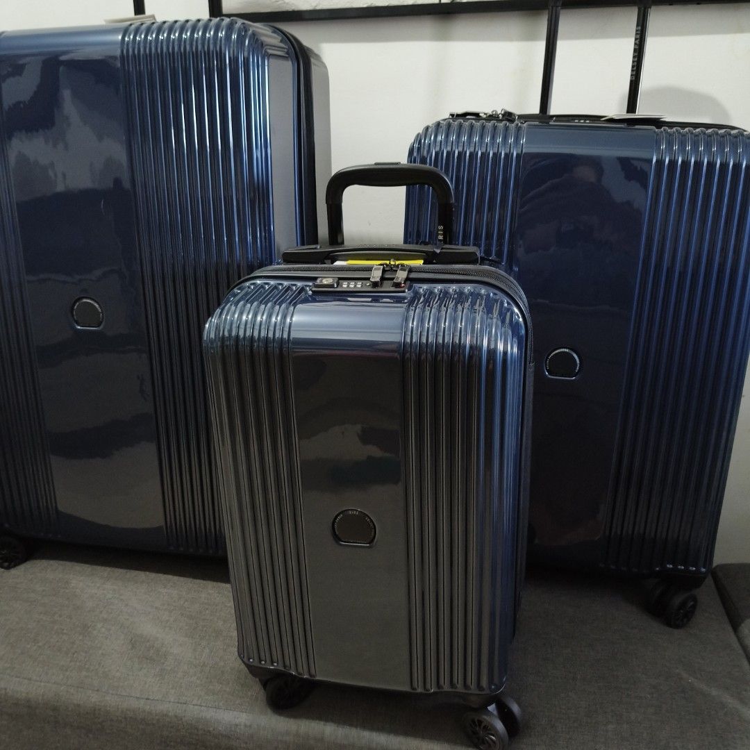 Delsey Luggage - Navy Blue (Category: Luggage) located in Caloocan City. Submitted by vtravelite.18 (Listing ID 1435418810, Image 2). Description: - Delsey luggage set in navy blue. - Set includes three pieces. - Features a stylish vertical ribbed design. - Each piece has a central circular detail. - Equipped with wheels and retractable handles for easy transport. price Starts @ small 7500 medium 85000 large 9500 - Made of durable, glossy materia