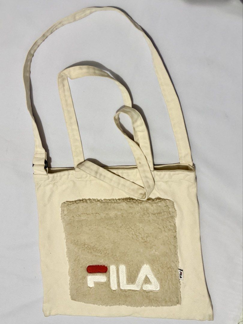 Fila Tote Bag with Shoulder Strap (Category: Tote Bags) located in Davao. Submitted by rebaggedph (Listing ID 1435384344, Image 1). Description: This FILA Canvas & Sherpa Tote Bag features a unique “popcorn” fleece front pocket with an embroidered logo and a versatile dual-handle design for use as a tote or shoulder bag. Measuring approximately 14” x 15”, it is in excellent pre-loved condition with a clean interior and intact tags. This functiona