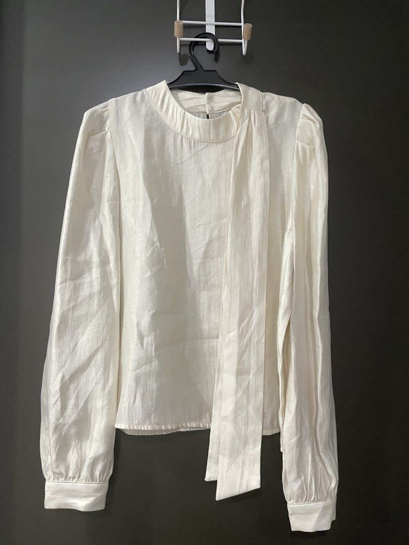 Formal White Blouse (Category: Blouses) located in Rizal. Submitted by ethriftstudios (Listing ID 1435445213, Image 1). Description: - The Luxe Studio white blouse. - Round neckline with tie detail. - Long sleeves with buttoned cuffs. - Slightly textured fabric. - Keyhole back. - Perfect for a sophisticated look..