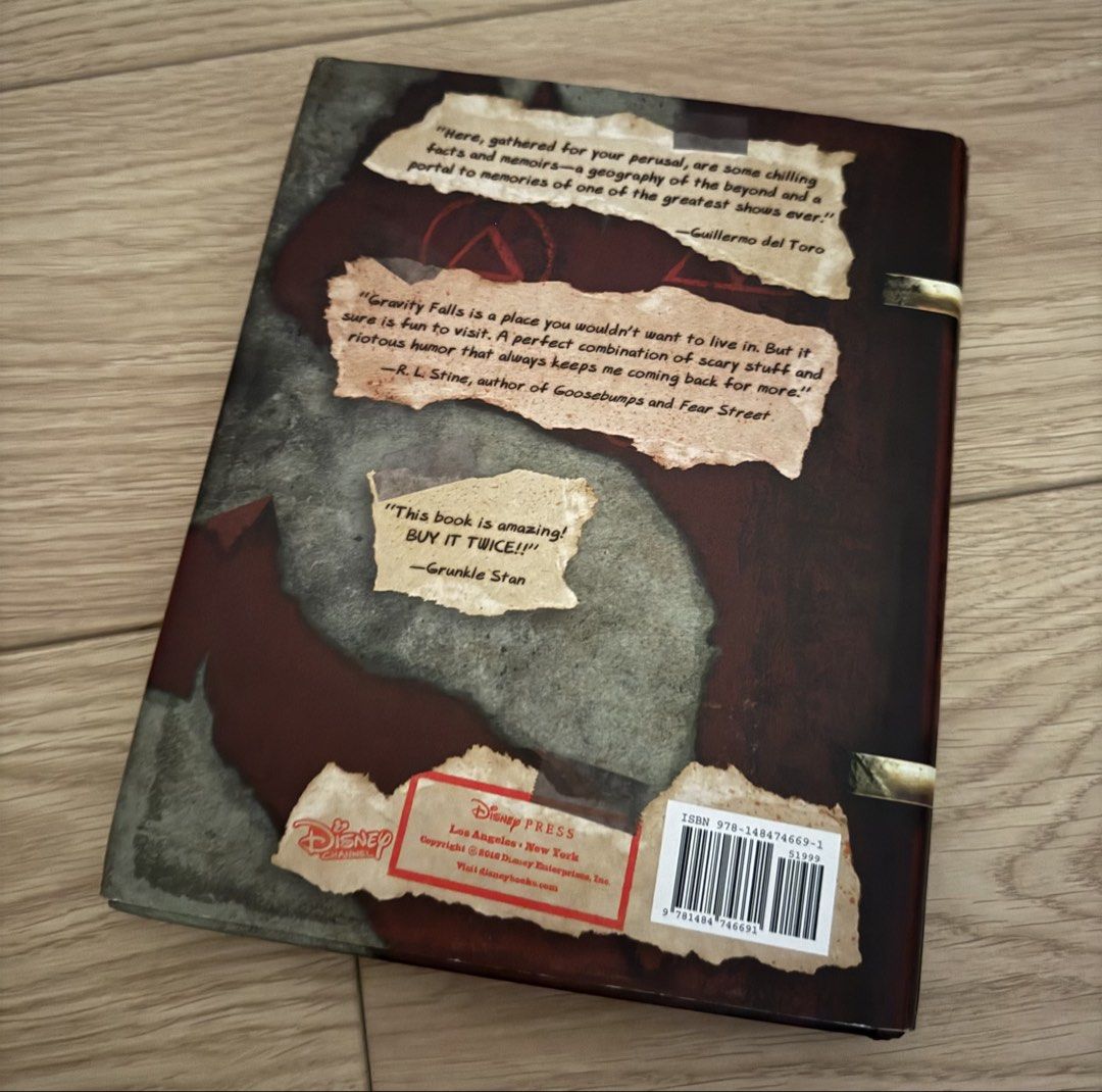 Gravity Falls Journal 3 (Category: Storybooks) located in Quezon City. Submitted by Tasi671 (Listing ID 1435341331, Image 2). Description: Gravity Falls Journal 3, a New York Times bestseller. It features the iconic hand and the number 3 on the cover. The back of the book includes quotes and the Disney Press logo. It's a great item for fans of the show. SRP 1,200.