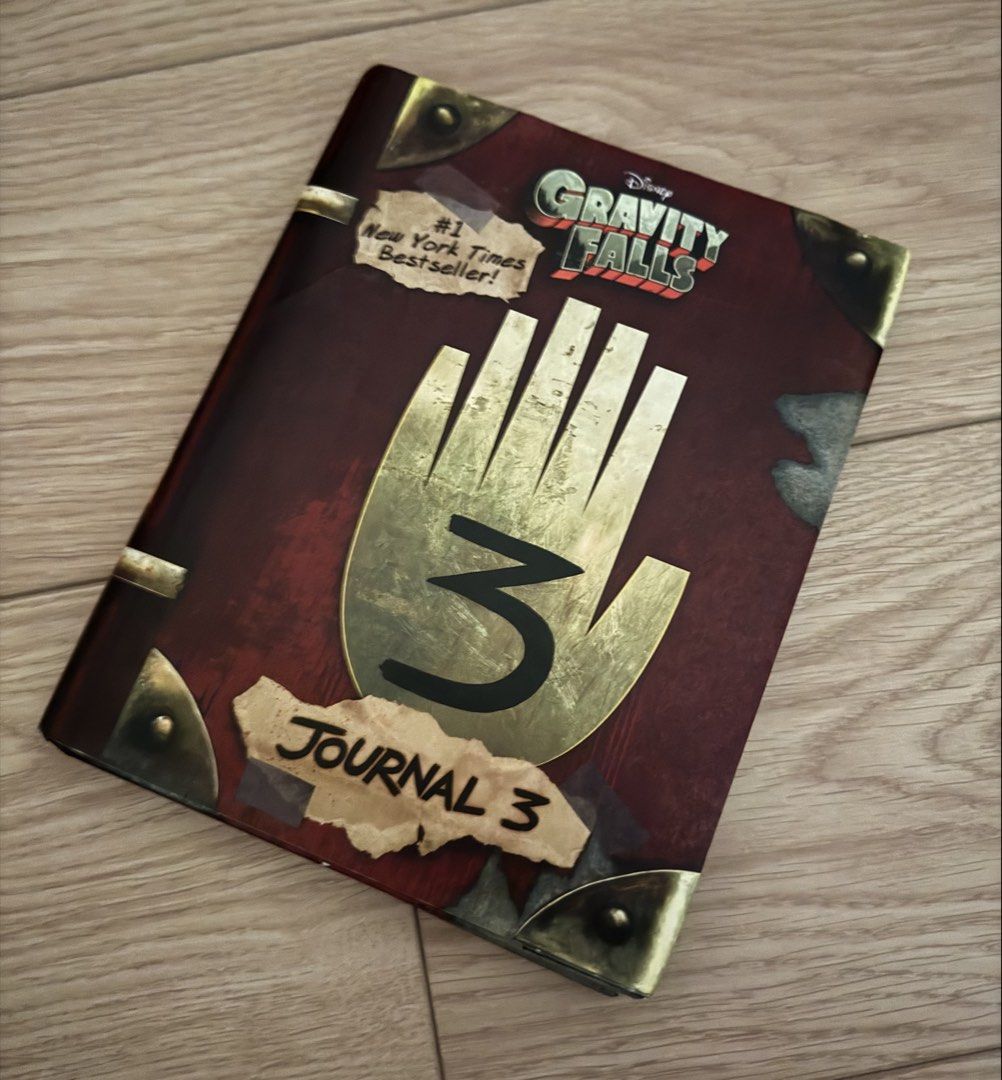 Gravity Falls Journal 3 (Category: Storybooks) located in Quezon City. Submitted by Tasi671 (Listing ID 1435341331, Image 1). Description: Gravity Falls Journal 3, a New York Times bestseller. It features the iconic hand and the number 3 on the cover. The back of the book includes quotes and the Disney Press logo. It's a great item for fans of the show. SRP 1,200.