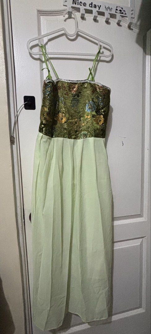 Green Floral Dress (Category: Dresses) located in Manila. Submitted by kykynsss (Listing ID 1435374693, Image 1). Description: Decluttering. Preloved Dress. Pick up only at Brgy La Paz Makati City - Elegant green dress - Floral detailing - Patterned bodice - Flowing, light green skirt - Thin, green straps - Zipper closure - Intricate floral patterns - Ideal for special occasions.