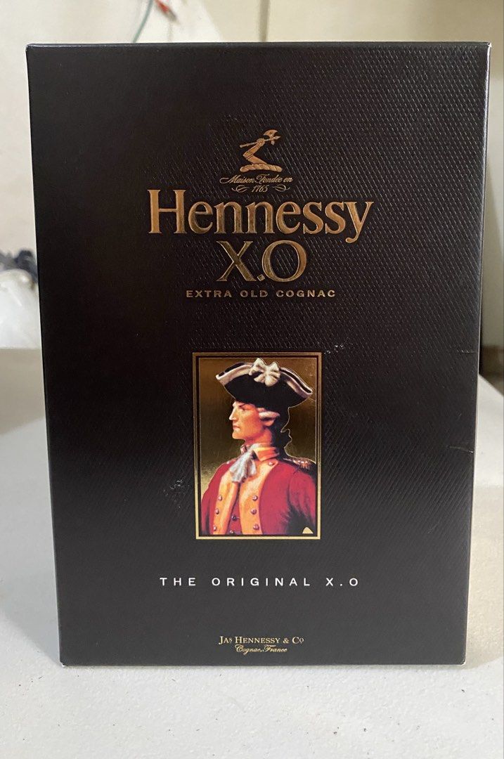 Hennessy X.O Extra Old Cognac (Category: Beverages) located in Quezon City. Submitted by bonth (Listing ID 1435399172, Image 1). Description: - Hennessy X.O Extra Old Cognac - 70cl bottle - 40% Alcohol by Volume (ABV) - Includes original box - Box features Hennessy logo and "Extra Old Cognac" text - Produced by Jas Hennessy & Co, Cognac, France - Box design includes a portrait of a man in a red coat.