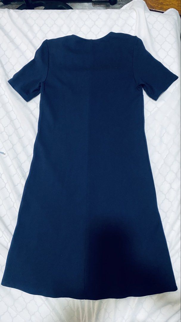 H&M Divided Dress (Category: Dresses) located in Quezon City. Submitted by smithram (Listing ID 1435406495, Image 2). Description: Navy blue dress from H&M Divided. Features a V-neckline with a white and red stripe design on the front. It has short sleeves and a knee-length cut. The dress is size EUR 34, US 2, CA 2, and MX 2. The dress has a simple, classic design suitable for various occasions..