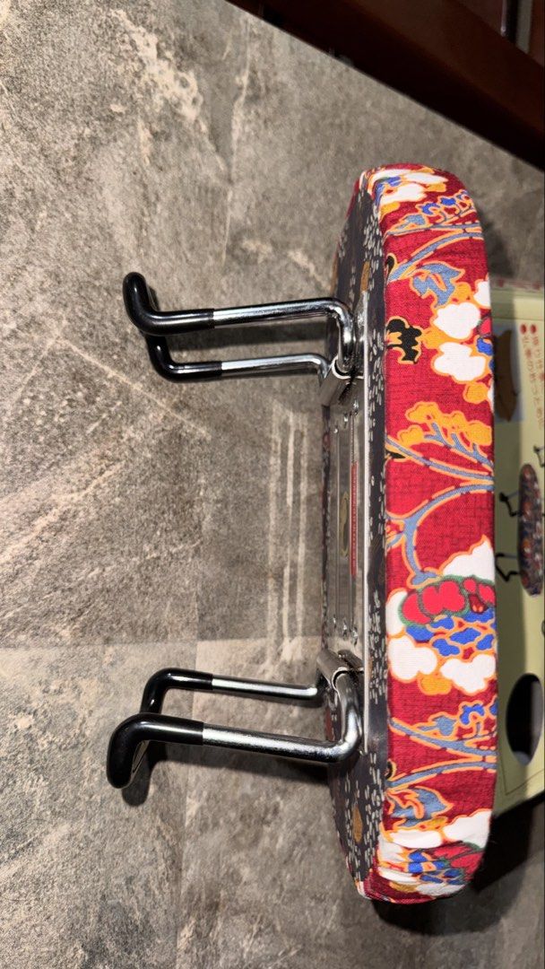 Japanese Folding Stool (Category: Chairs) located in Santa Cruz. Submitted by maqui15 (Listing ID 1435359252, Image 3). Description: - Japanese folding stool - Features a vibrant red floral pattern - Sturdy metal frame with black handles - Brand new in original packaging - Includes decorative fabric cover - Compact and foldable for easy storage.