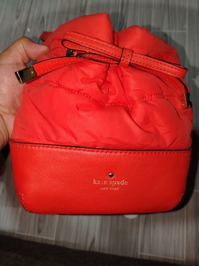 Kate Spade Red Bucket Bag (Category: Luxury Bags & Wallets) located in Munoz. Submitted by makie_ukay (Listing ID 1435481301, Image 2). Description: - Kate Spade bucket bag - Vibrant red color - Drawstring closure - Leather base - Long strap for shoulder/crossbody wear - Lined interior - Bow detail on the front need wash only.
