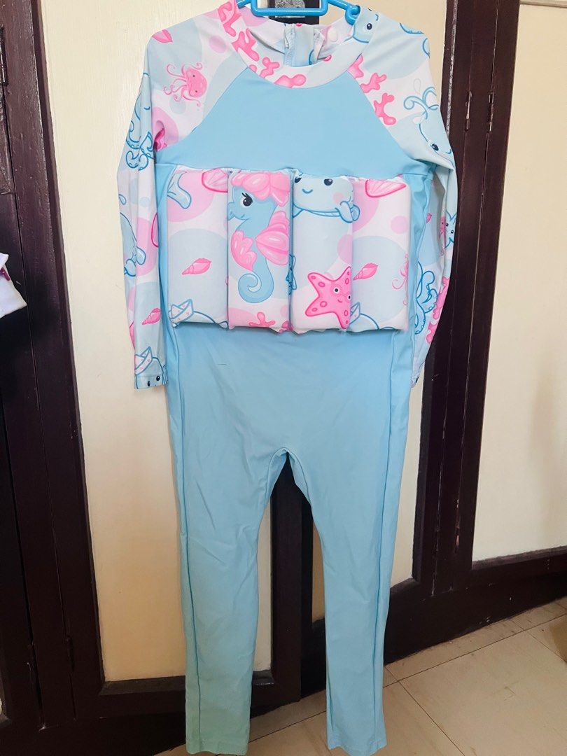 Kids' Swimsuit with Floaties (Category: Babies & Kids Fashion) located in Marikina City. Submitted by declutteringcarly (Listing ID 1435375913, Image 1). Description: - Light blue long-sleeved and long-legged swimsuit - Features a fun sea creature design - Includes built-in floaties for added safety.