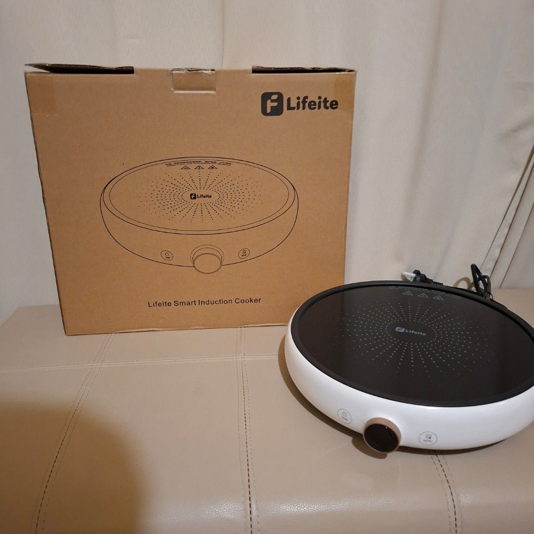 Lifeite Smart Induction Cooker xiaomi oled knob (Category: Cookers) located in Pasig City. Submitted by fast-ship (Listing ID 1435397381, Image 2). Description: - Lifeite Smart Induction Cooker - Features a white body and black cooking surface - Control panel with buttons and knob - Comes with the original box, which includes a product diagram.