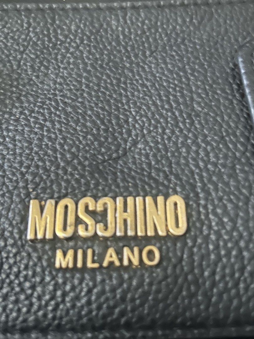 Moschino Milano Black Shoulder Bag (Category: Shoulder Bags) located in Quezon City. Submitted by asiaco (Listing ID 1435386868, Image 3). Description: Moschino Milano black shoulder bag. Features a front zipper pocket, gold hardware, and a flap closure with logo. The C is reversed and the brand inside is not moschino. I bought this online at a much higher price, i was not told of the discrepancies. However, the bag is still cute and unique. It i