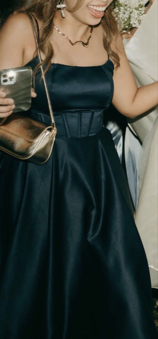 Navy Blue Gown or Dress (Category: Dresses) located in Manila. Submitted by aaavillena (Listing ID 1435405555, Image 2). Description: - Elegant navy blue formal dress - Fitted bodice with spaghetti straps - Wide waistband - Floor-length skirt with a slight train - Made of smooth, Duchess satin fabric - Ideal for special events.