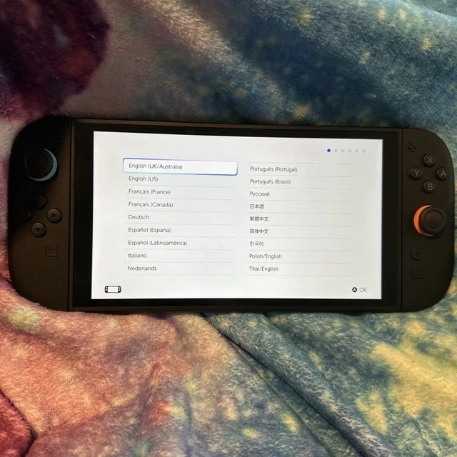 Nintendo Switch Console (Category: Nintendo) located in New Bataan. Submitted by newgem.15937b (Listing ID 1435341343, Image 2). Description: - Nintendo Switch console - Includes console and controllers - Features black controllers with blue and orange joysticks.