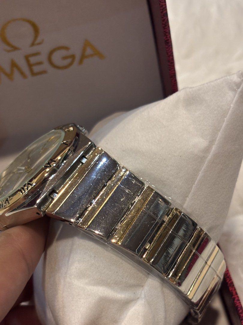 Omega Constellation Watch (Category: Luxury Watches) located in Cebu City. Submitted by day.98 (Listing ID 1435470724, Image 3). Description: - Omega Constellation watch - Silver dial with gold accents - Features Roman numeral hour markers - Date display function - Two-tone stainless steel and gold bracelet - Comes with original Omega box.