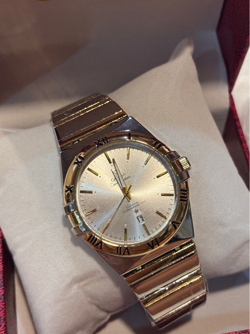 Omega Constellation Watch (Category: Luxury Watches) located in Cebu City. Submitted by day.98 (Listing ID 1435470724, Image 2). Description: - Omega Constellation watch - Silver dial with gold accents - Features Roman numeral hour markers - Date display function - Two-tone stainless steel and gold bracelet - Comes with original Omega box.
