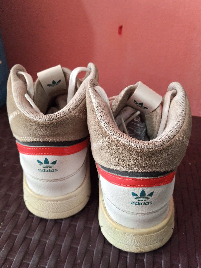 Original Adidas High-Top Sneakers 36 (Category: Sneakers) located in Daet. Submitted by ahyazheabea (Listing ID 1435349915, Image 3). Description: - Vintage Adidas high-top sneakers - White leather upper - Green and red accents - Adidas logo on tongue - High-top design with padded collar - Size: US 7.5 / UK 7 / FR 40 2/3 - Made in Vietnam.