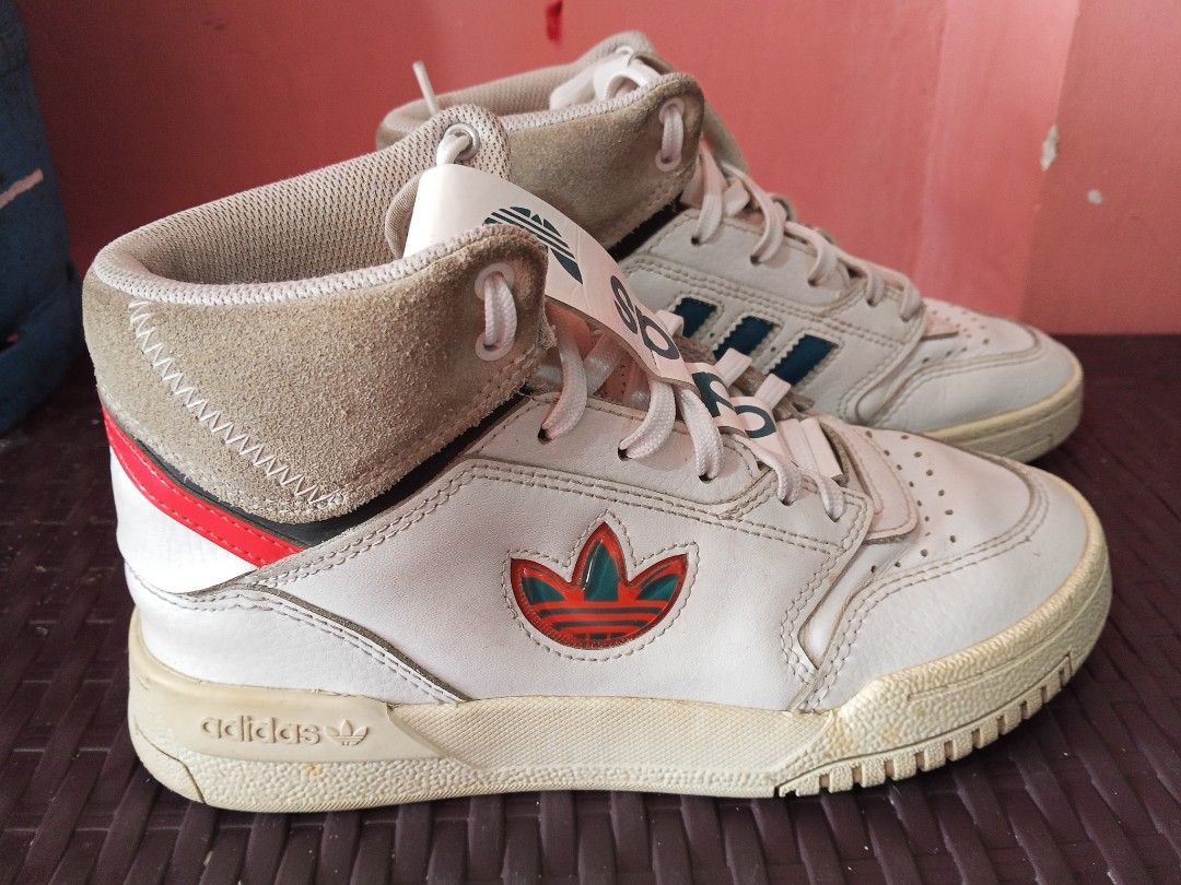 Original Adidas High-Top Sneakers 36 (Category: Sneakers) located in Daet. Submitted by ahyazheabea (Listing ID 1435349915, Image 2). Description: - Vintage Adidas high-top sneakers - White leather upper - Green and red accents - Adidas logo on tongue - High-top design with padded collar - Size: US 7.5 / UK 7 / FR 40 2/3 - Made in Vietnam.