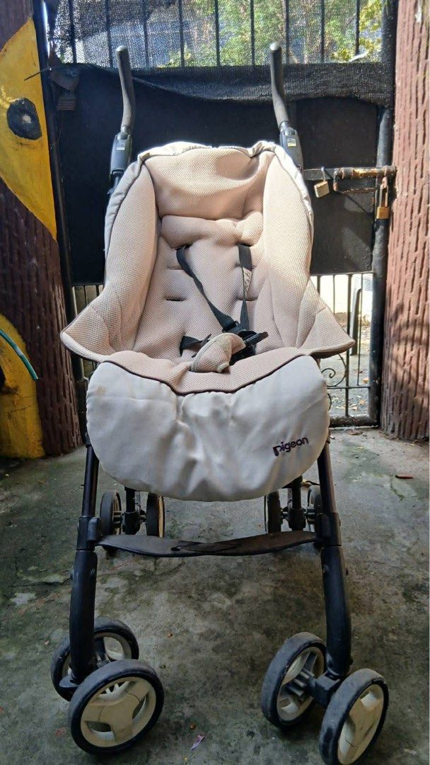 Pigeon Stroller (Category: Strollers) located in Cagayan de Oro. Submitted by jackycas85 (Listing ID 1435389338, Image 3). Description: - Beige seat with safety harness - Dark, stable frame - Curved handles for easy maneuvering - Multiple wheels for stability - Designed for comfort and ease of use.
