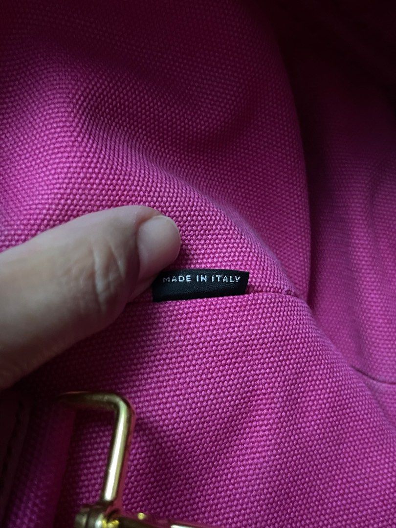 Prada Canapa Tote Bag (Category: Luxury Bags & Wallets) located in Muntinlupa City. Submitted by karmeeda_p (Listing ID 1435455058, Image 3). Description: Price negotiable. No to low-ballers - Authentic Prada Canapa tote bag - Color: Pink - Material: Canvas - Hardware: Gold-tone - Includes: Detachable strap and authenticity cards - Features Prada logo - Gold studs on the bottom - Made in Italy.