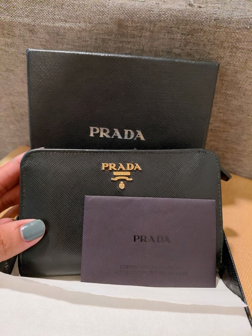Prada Saffiano Leather Zip Wallet (Category: Luxury Bags & Wallets) located in Makati City. Submitted by jisla (Listing ID 1435510133, Image 3). Description: - Authentic Prada wallet - Black Saffiano leather - Gold-tone hardware - Prada logo - Zip closure - Includes box, authenticity card, and dust bag - Multiple compartments - Stylish and functional.