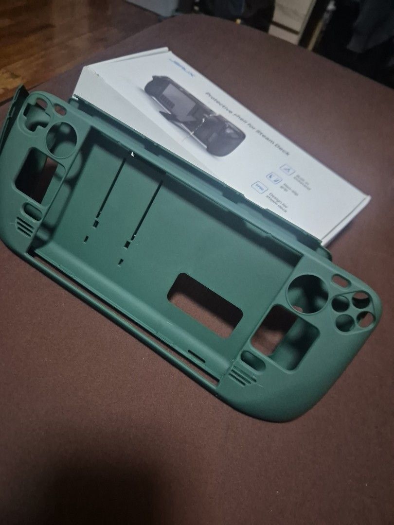 Protective Shell for Steam Deck (Category: Cases & Covers) located in Pasig City. Submitted by dseve (Listing ID 1435491966, Image 3). Description: - Green protective shell for Steam Deck - Features a built-in kickstand - Designed to protect against scratches and impacts - Includes the original box (box with damage) -never been used, just stored.
