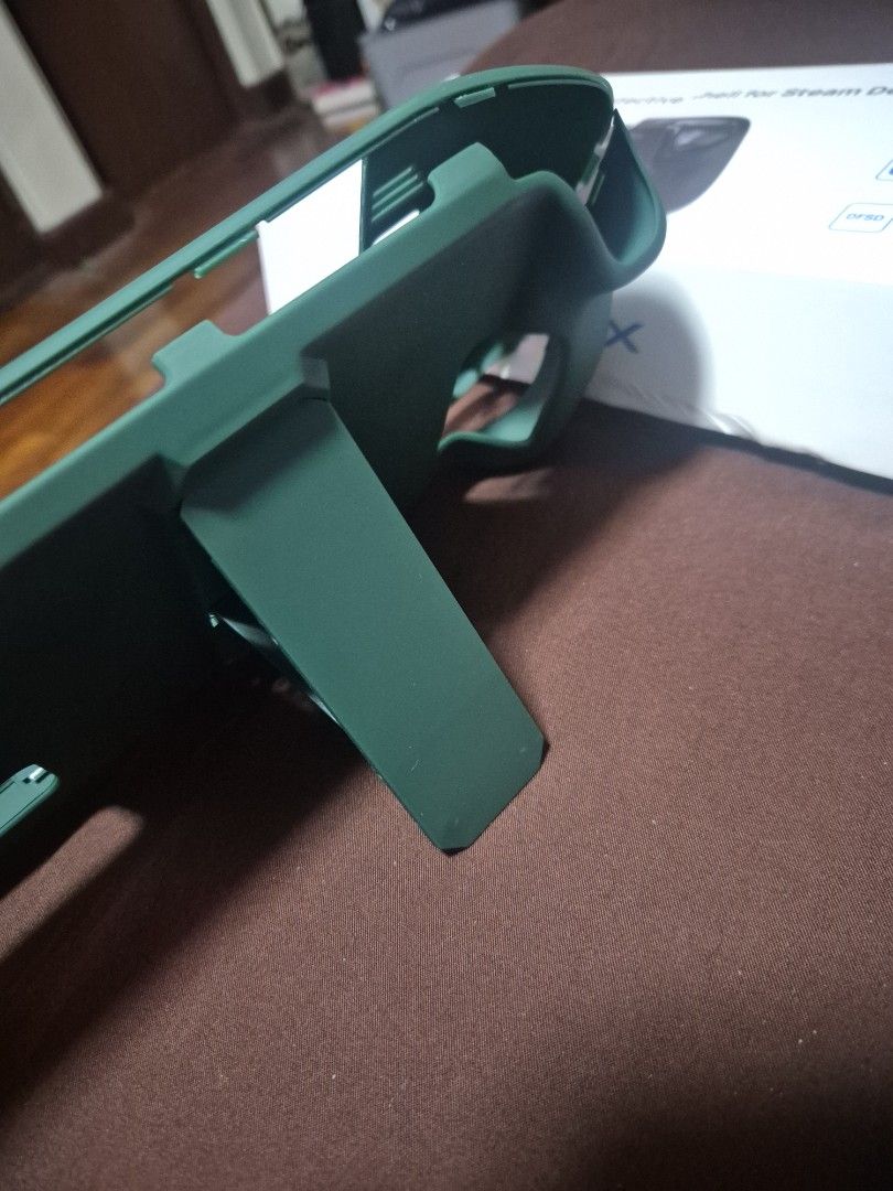 Protective Shell for Steam Deck (Category: Cases & Covers) located in Pasig City. Submitted by dseve (Listing ID 1435491966, Image 2). Description: - Green protective shell for Steam Deck - Features a built-in kickstand - Designed to protect against scratches and impacts - Includes the original box (box with damage) -never been used, just stored.