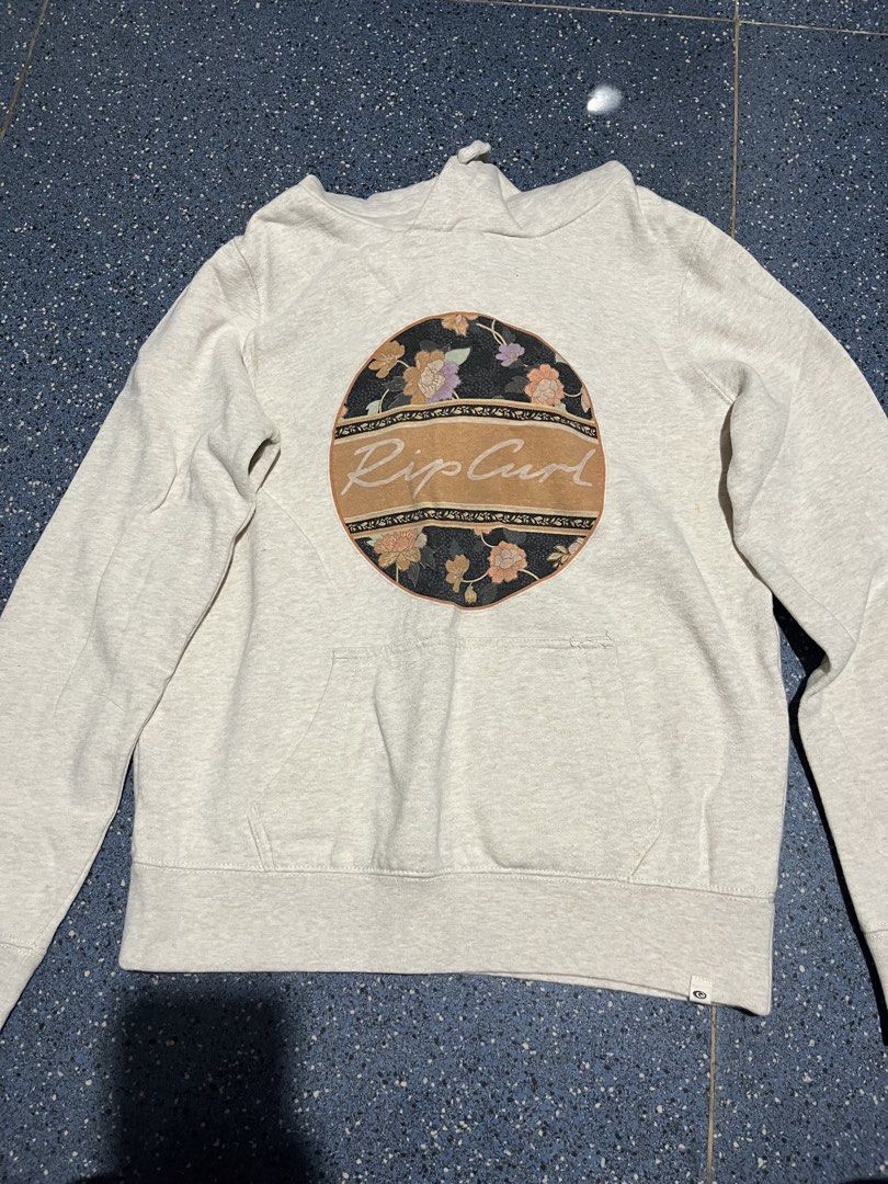 Rip Curl Floral Graphic Hoodie (Category: Coats, Jackets and Outerwear) located in Manila. Submitted by hi_abbd (Listing ID 1435427750, Image 1). Description: - Rip Curl hoodie - Features a floral graphic - Kangaroo pocket - Drawstring hood - Light color - Rip Curl logo on hem - Size: XXS Has small stain attached in the last photo Too small on me No when worn.