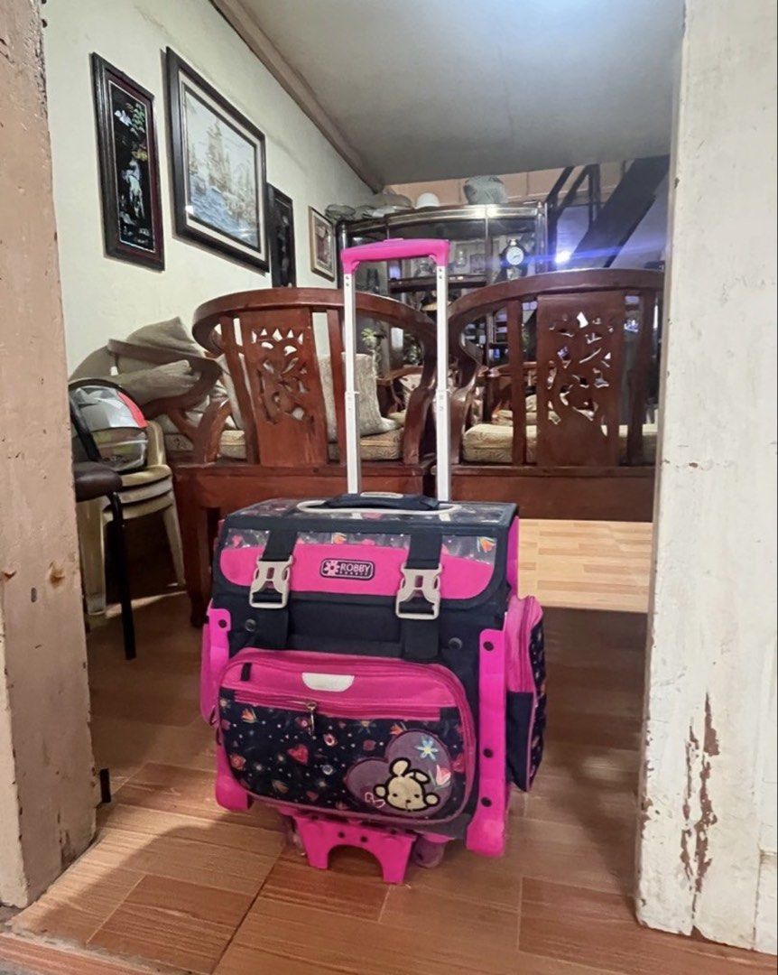 Robby Rabbit Rolling School Bag (Category: Babies & Kids Fashion) located in Candon. Submitted by dhinlei07 (Listing ID 1435405109, Image 1). Description: - Robby Rabbit rolling school bag - Pink and navy blue color scheme - Multiple compartments for organization - Handle and wheels for easy transport - Includes name tag slot - Spacious for books and supplies - Dimensions: 45L x 26W x 36H cm - Capacity: 42L .