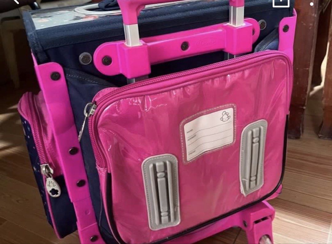 Robby Rabbit Rolling School Bag (Category: Babies & Kids Fashion) located in Candon. Submitted by dhinlei07 (Listing ID 1435405109, Image 3). Description: - Robby Rabbit rolling school bag - Pink and navy blue color scheme - Multiple compartments for organization - Handle and wheels for easy transport - Includes name tag slot - Spacious for books and supplies - Dimensions: 45L x 26W x 36H cm - Capacity: 42L .