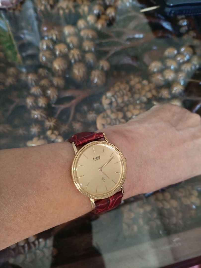 Seiko Quartz Gold Watch with Leather Strap (Category: Women's Watches) located in General Trias. Submitted by smyls (Listing ID 1435459824, Image 2). Description: - Seiko quartz watch - Gold-toned face and case - Burgundy genuine leather strap - Classic and simple design - Silver-toned back.