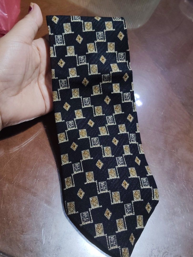 Valentino Cravatte Collection Silk Tie (Category: Ties) located in Cebu City. Submitted by almzcorner (Listing ID 1435418119, Image 1). Description: - Valentino Cravatte Collection tie - Black base with gold and silver geometric pattern - 100% silk - Handmade in Italy - Features the Valentino Cravatte Collection label - Ideal for formal wear.