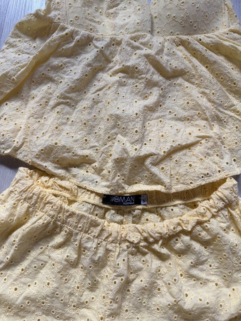 Woman Sleepwear Yellow Eyelet Set (Category: Undergarments & Loungewear) located in Quezon City. Submitted by confessionsofshopaholics (Listing ID 1435456605, Image 2). Description: - Woman Sleepwear yellow eyelet set - Includes halter top with ruffled design - Shorts feature an elastic waistband - Made of lightweight fabric - Ideal for warm weather.