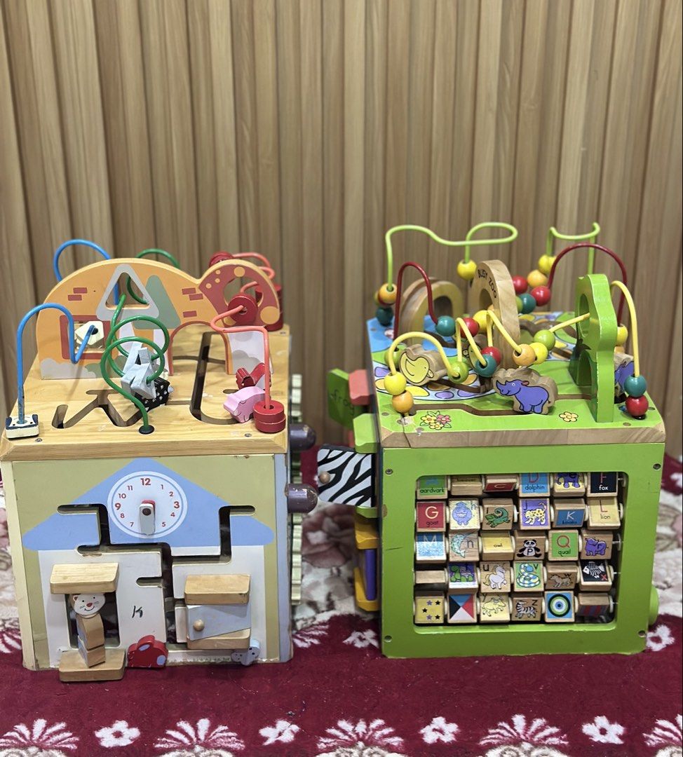 Wooden Activity Cube - Busy Zoo (Category: Infant Playtime) located in Manila. Submitted by olaine29 (Listing ID 1435409043, Image 2). Description: - Wooden activity cube for toddlers and young children. - Multiple sides with engaging activities. - Includes bead mazes, shape sorters, and gears. - Features bright colors and animal-themed illustrations. - Helps develop fine motor skills and cognitive abilities. - size : 11.5 in length x 12 in width