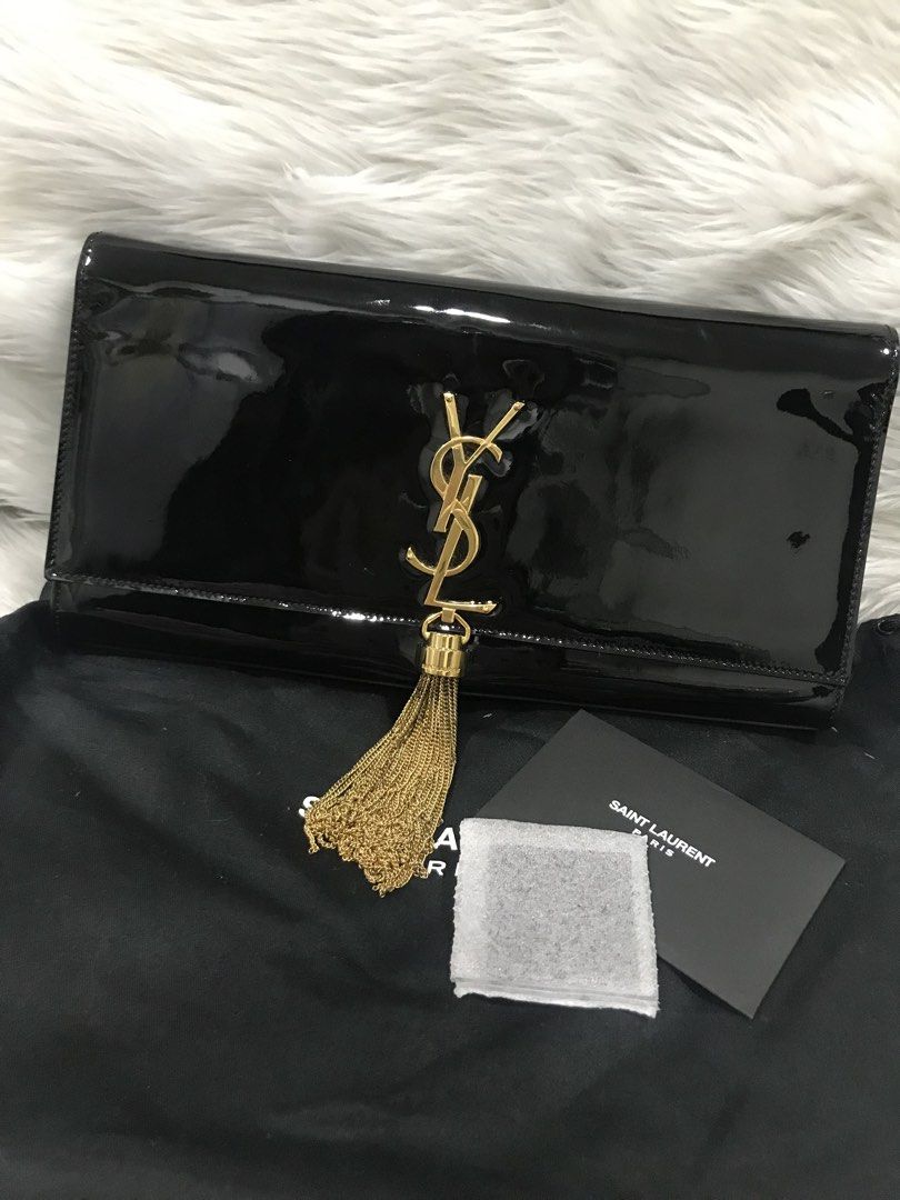 YSL Black Clutch Bag with Tassle (Category: Luxury Bags & Wallets) located in Quezon City. Submitted by venchar (Listing ID 1435510210, Image 1). Description: - Authentic Saint Laurent clutch - Black patent leather - Gold YSL logo - Tassel detail - Includes dust bag, care card, and cleaning cloth.