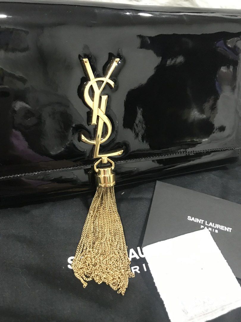 YSL Black Clutch Bag with Tassle (Category: Luxury Bags & Wallets) located in Quezon City. Submitted by venchar (Listing ID 1435510210, Image 2). Description: - Authentic Saint Laurent clutch - Black patent leather - Gold YSL logo - Tassel detail - Includes dust bag, care card, and cleaning cloth.