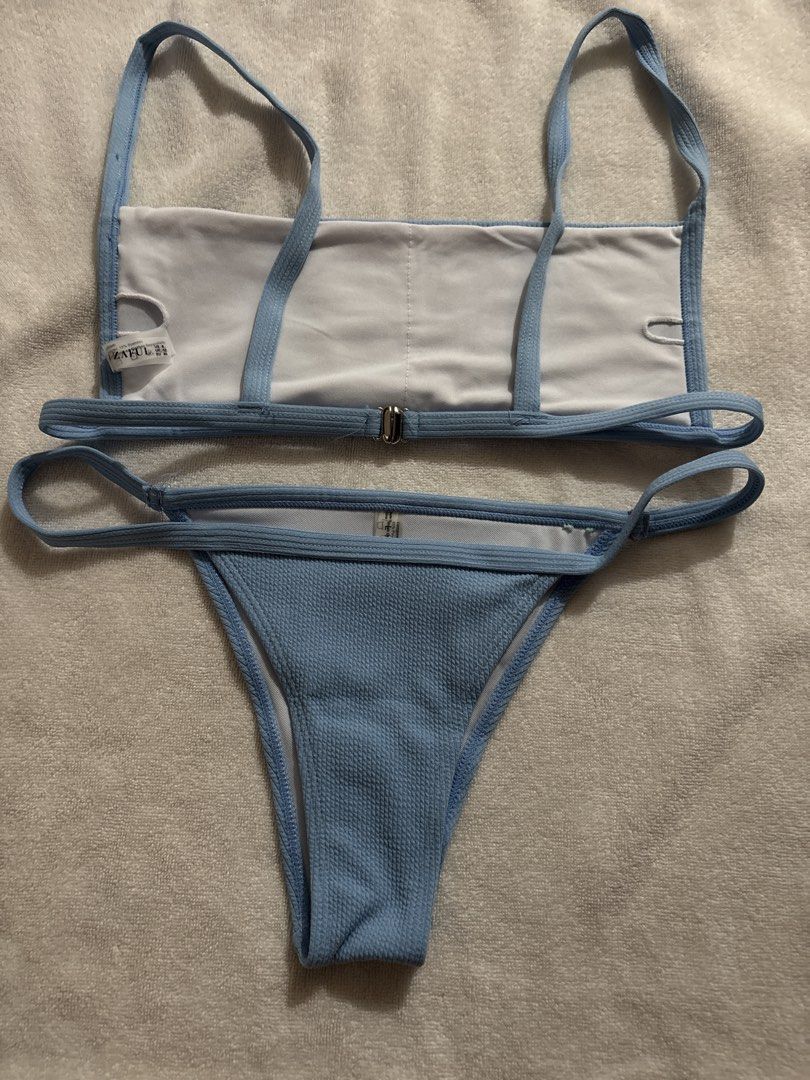 ZAful Blue Bikini Set (Category: Bikinis & Swimsuits) located in Makati City. Submitted by ell_declutter (Listing ID 1435382129, Image 2). Description: ZAful bikini set features a light blue color. The top has a square neckline and straps. The bottom is a thong style. The size is US 8, EU 40. The material composition is 95% Polyester and 5% Spandex. The bikini has a clasp closure at the back..